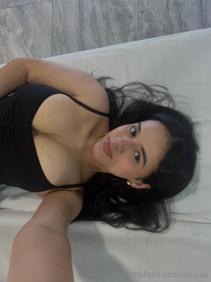 A dimly lit room soft sheets and rain tapping against the window while 