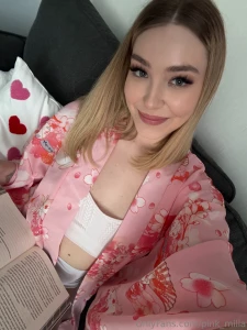 A cozy evening in a pink kimono a book a pillow with hearts and a good