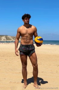 A beautiful beach nice short perfect weather and a volleyball what