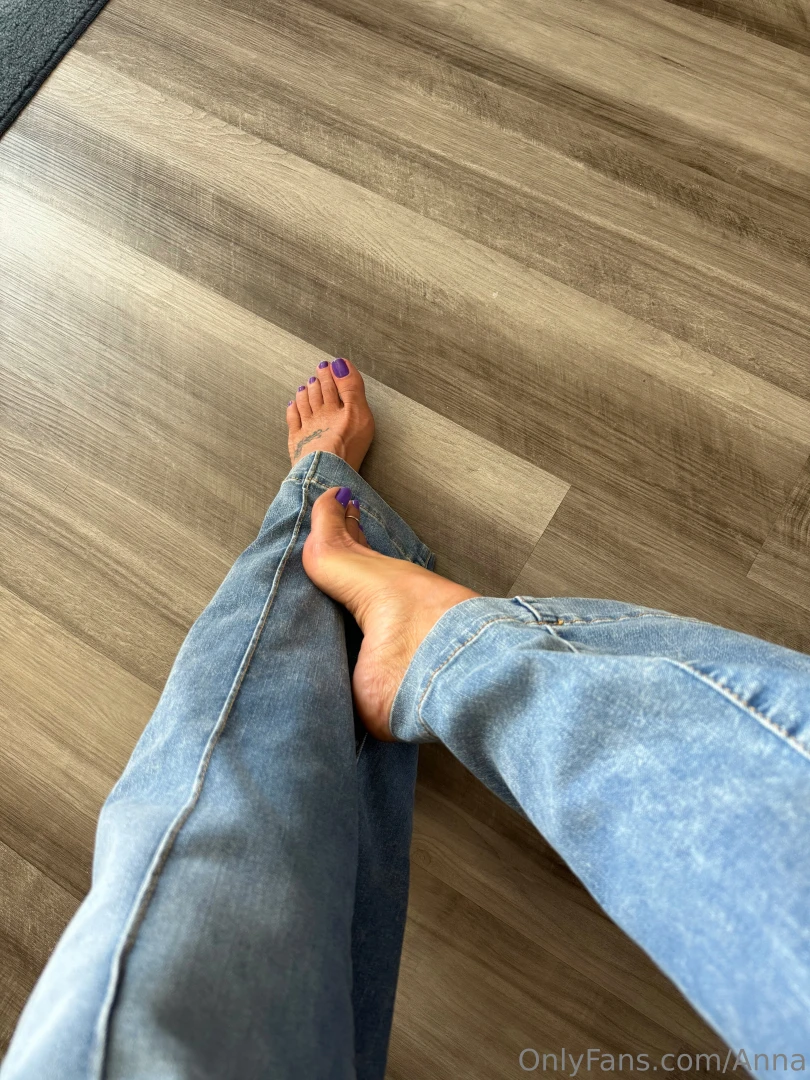 Blue jeans and purple toes 
