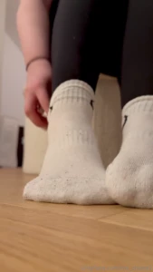 I slowly take off my damp sports socks the sweat-soaked fabric