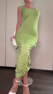 I m in a beautiful long green dress in high heels moving slowly to the