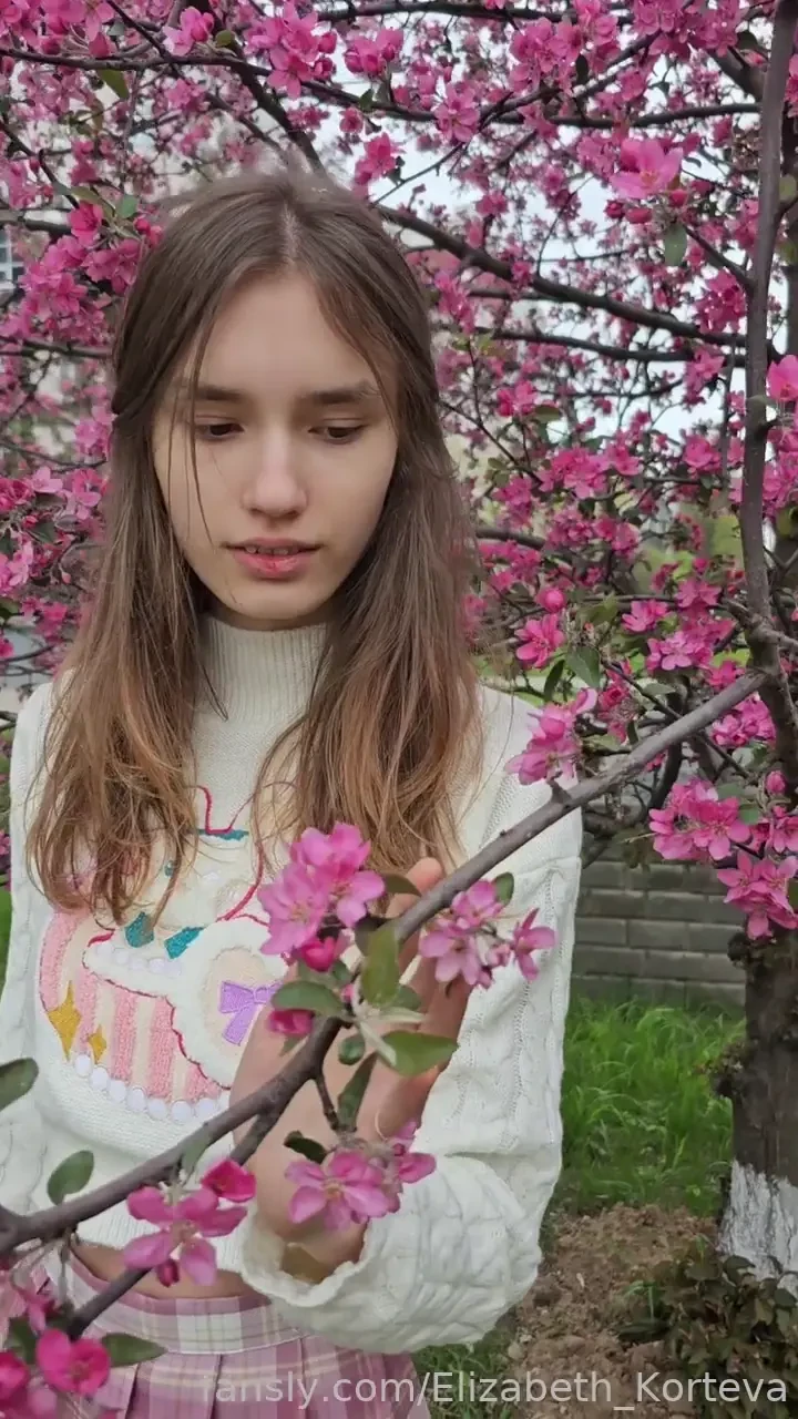 Cute sexy student and spring student plaidskirt outside flowers 