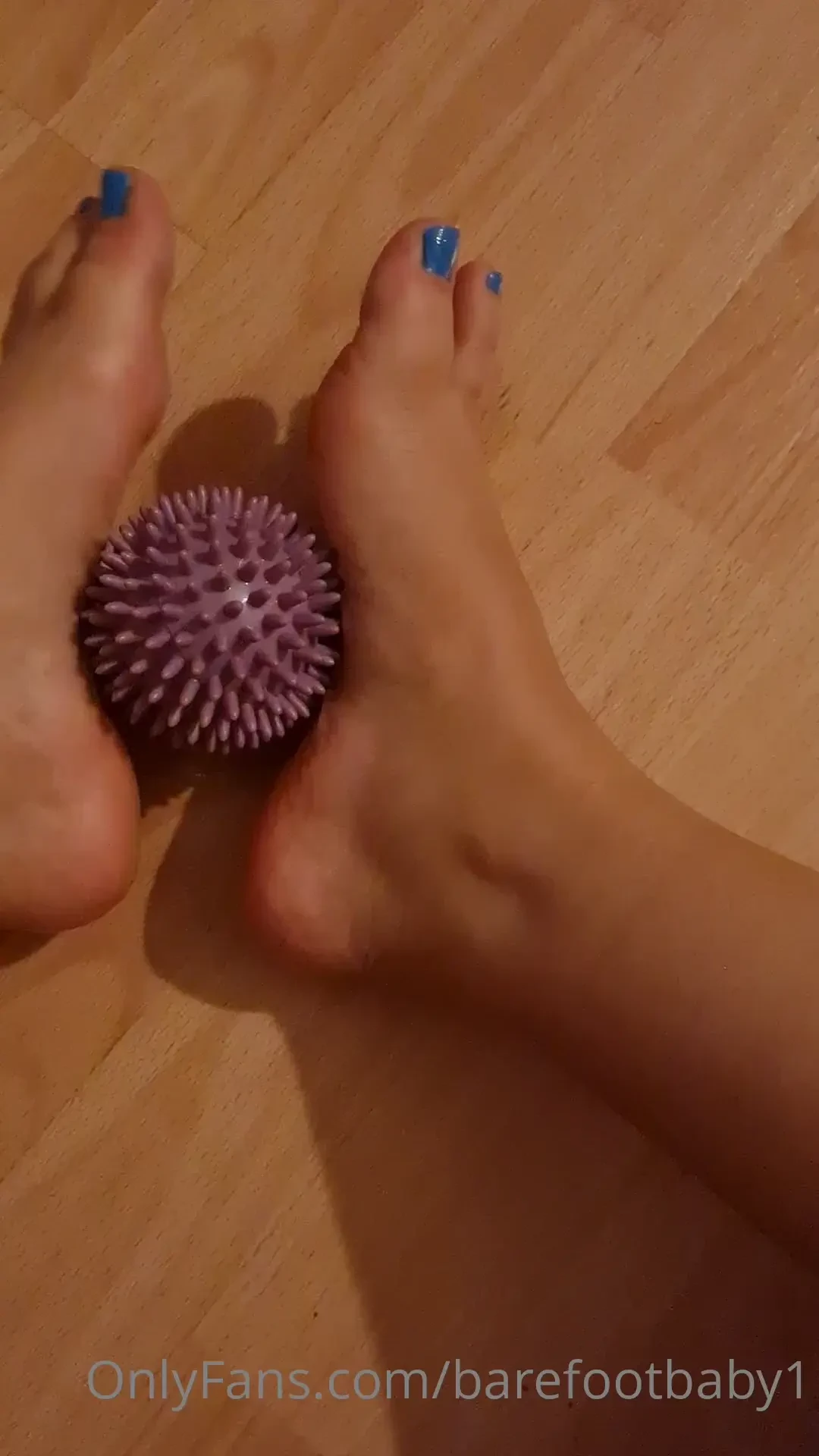 Massaging my feet with a spiky massage ball 