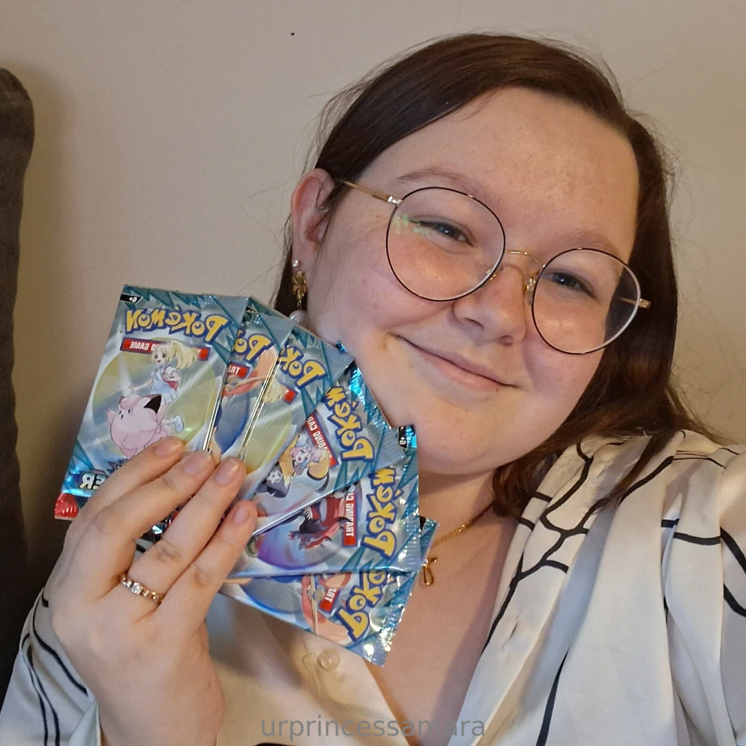 A pretty girl and pok mon cards what more could you want 