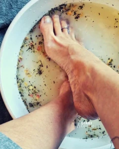 Foot bath with oat milk essential oils herbs and dried flowers a