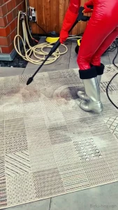 In hunter and red bodysuite clean the terrace with the pressure washer part 1