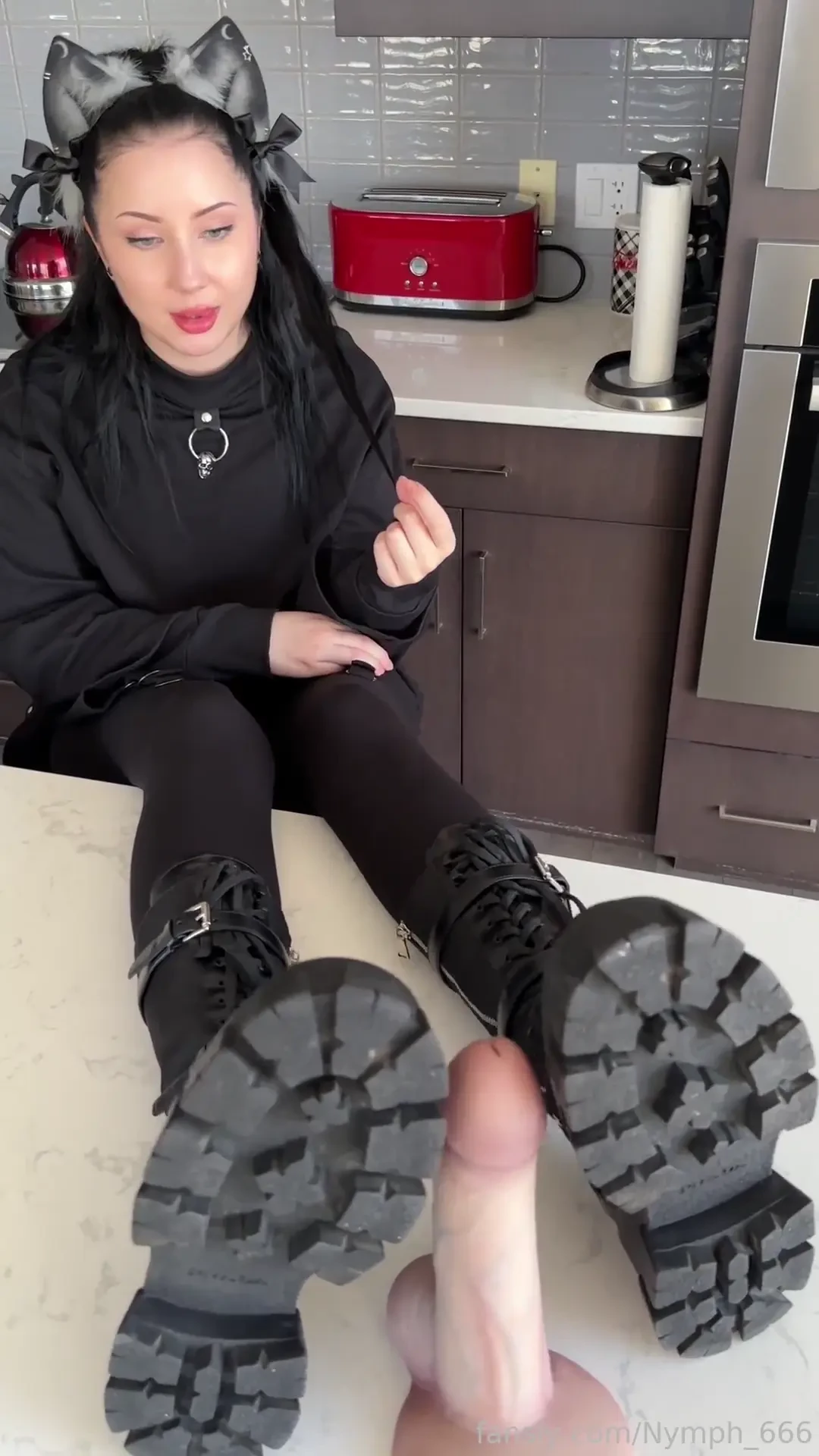 Gothic cat girl uses her big feet to play with a 9 inch cock while 