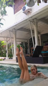 Tanned naked and wet enjoy this open leg moment by the pool