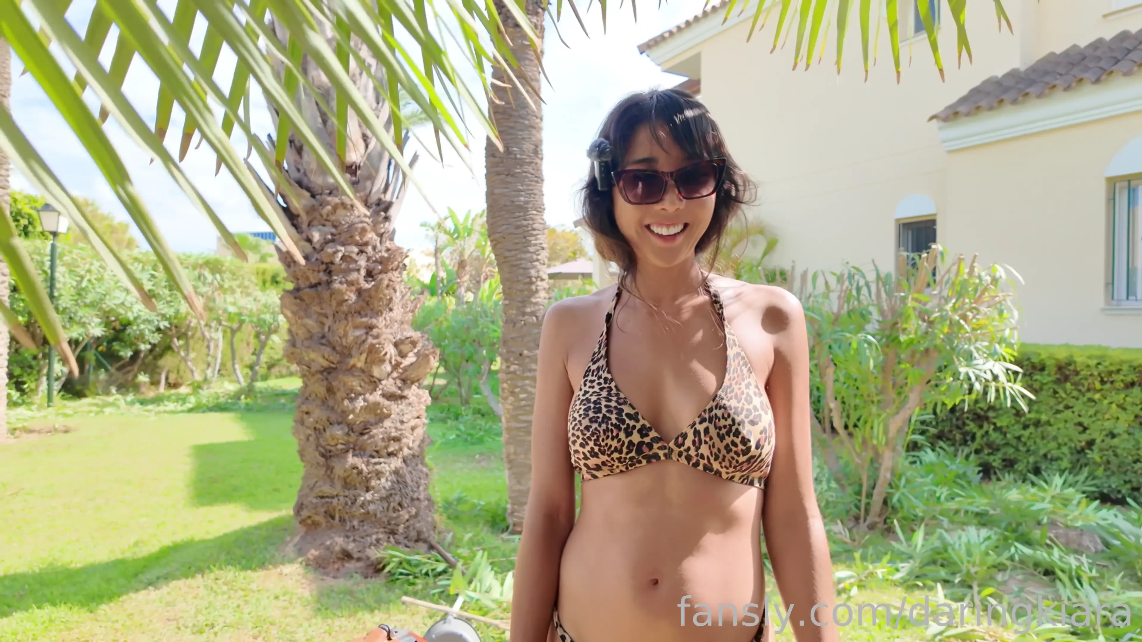 Cutting some leaves off trees in my tiny bikini in front of two 