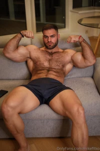 Posted on the couch shirt off flexed up cock thick and hard in my