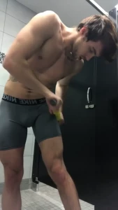 Rolling out my legs and glutes in the locker room as close to naked as