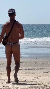 Rocking my thong swimsuit at the beach and grabbing a fresh coconut