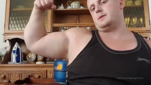Flexing biceps and showing where they measure over 21