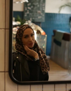 I m standing by the mirror palm pressed to my cheek as if trying to