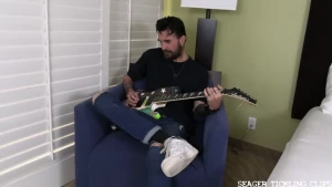 Tall dark and handsome bennett is a guitarist for a rock band standing