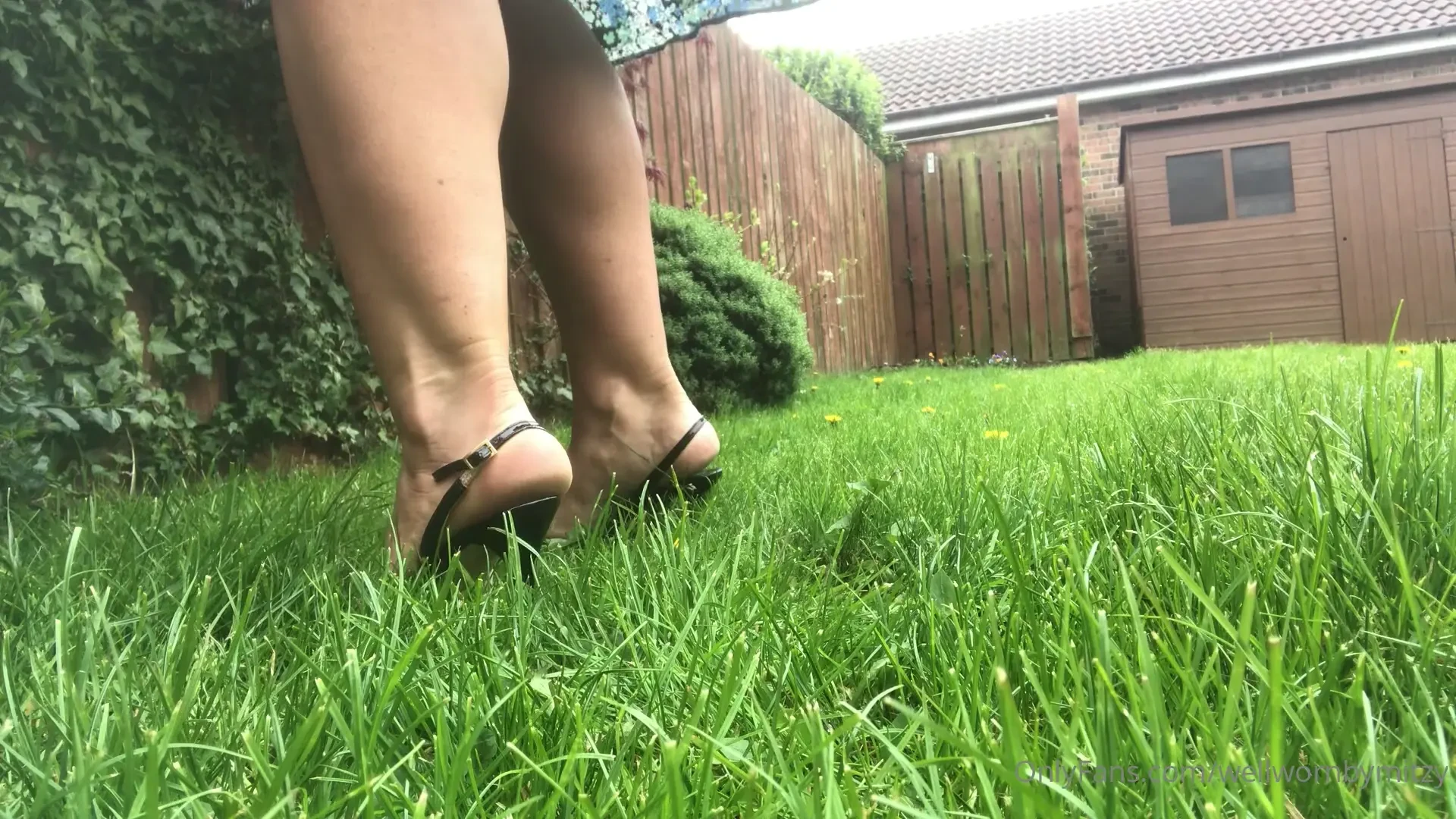 Jimmy choo slim stiletto sling backs sinking into the grass 