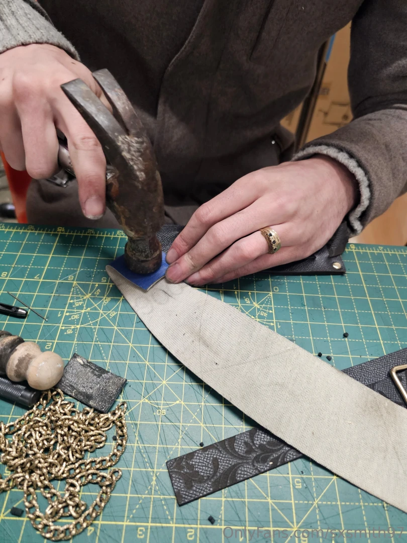 This man s hands making the finishing touches to the cuffs full set to 