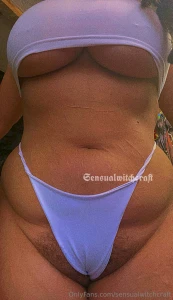 Curvy girl in a crop top with her tummy showing and boobs spilling out