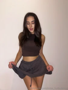 Happy girl on the ground but still dressed like she s got turbulence