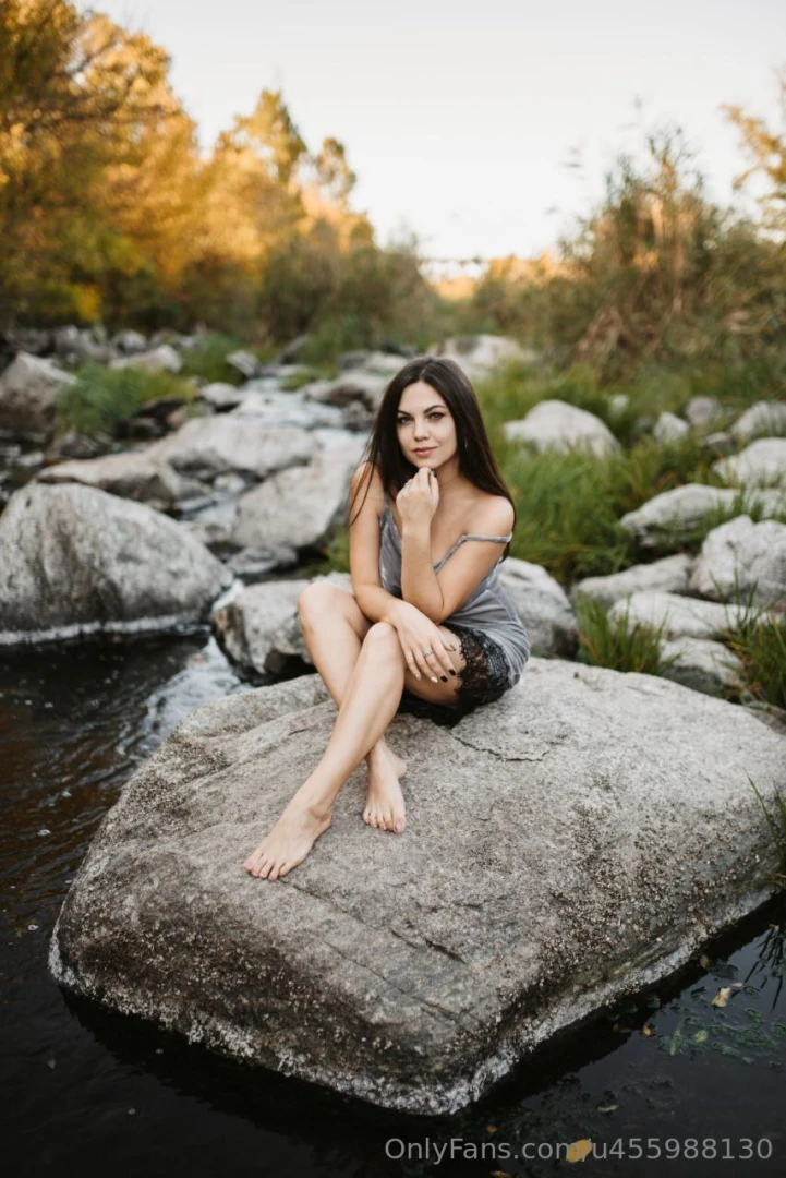 Perched on this rock like nature s favorite tease legs crossed lips 