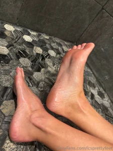 Close up feet soles arched and toes covered in oil part 3