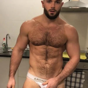 I show off my hairy body in a jockstrap jerk off and cum watching to