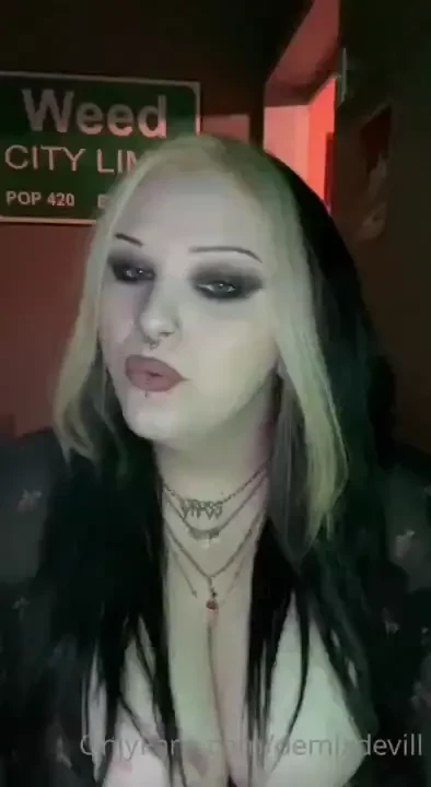 Vibe to music and smoke with a goth girl taking deep inhales and 