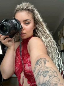 In a red top and with a camera in her hands she is ready to capture