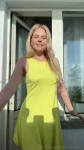 Wearing a bright dress basking in the sun and feeling absolutely
