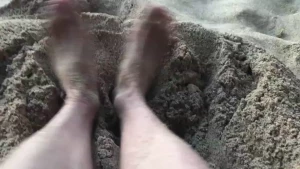 Sandy feet playing in the sand