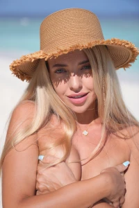 On the beach under the sun wearing my hat and covering my bare chest part 1