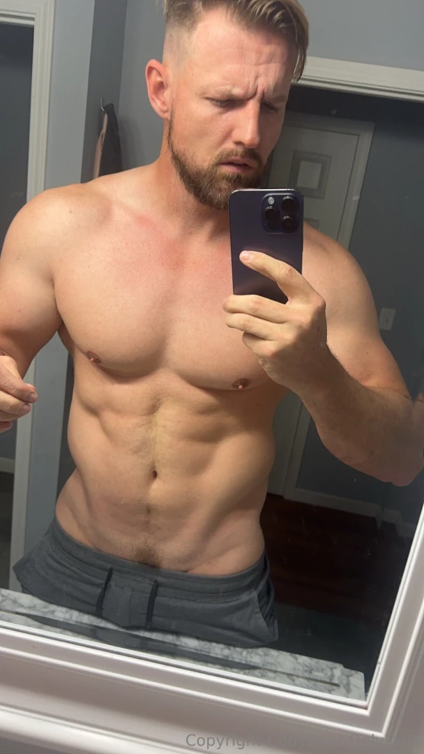 Your thick daddy flexing for you in his bathroom mirror and gives you 