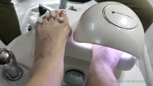 Asian boy painting my nails in the beauty salon in warsaw he is very