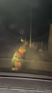 Taking turns to pee in front of the car nearby to the service station