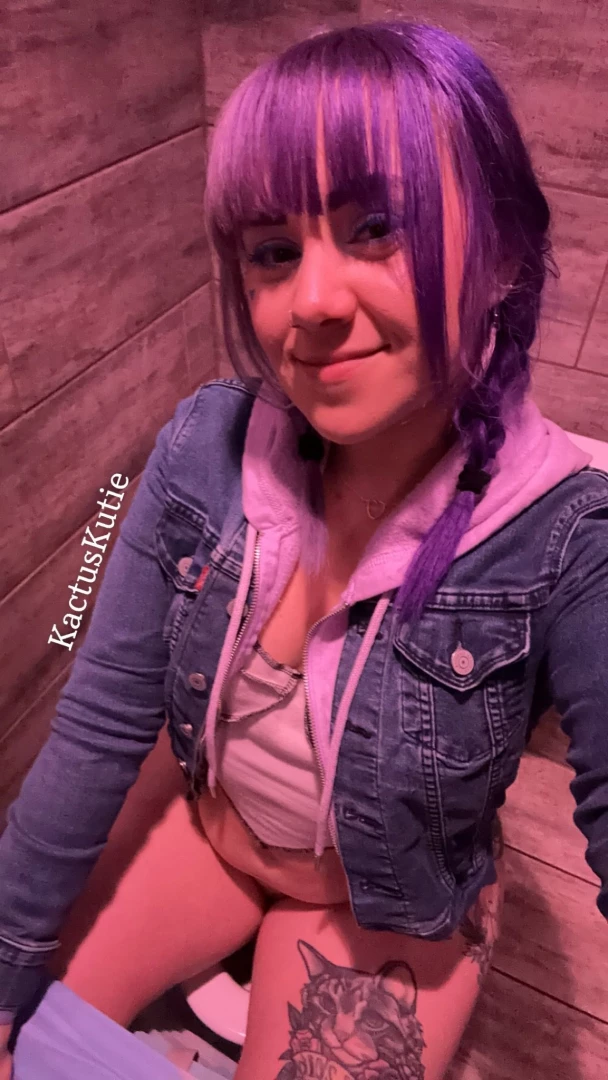 Peeing in a public bathroom with pink light 