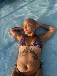 Sun-kissed and tattooed by the poolside