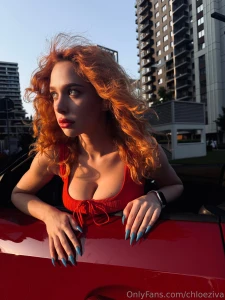 Red-headed girl in a red car combo