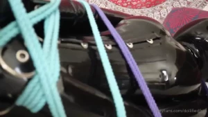 One horny latex-bound inflatable doll complete with rope chains and