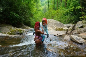 Picture set of 2 lesbians and horny clown fucking at a waterfall