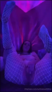 Wearing a white fishnet bodysuit that glows under my black light