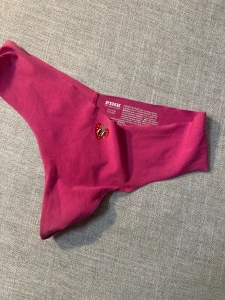 From the second row 1 light pink lace thong with pink rose above pussy