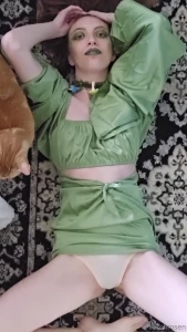 I am laying on the floor in my green dress caressing myself playing