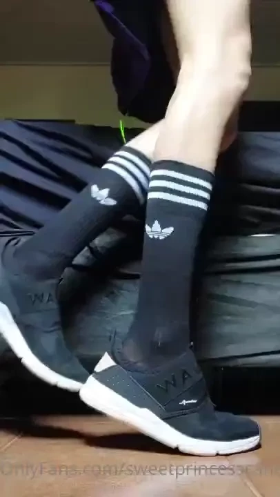 Shoe removal showing off my black long socks 
