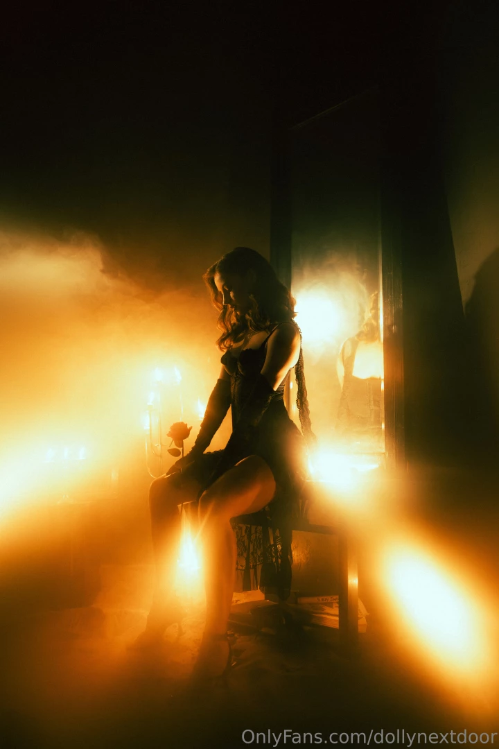 The rose in her hands is like a memory of something unspoken 