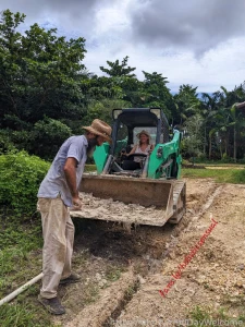 Breatheasy shoveling sand into irrigation pipe ditches while drive the