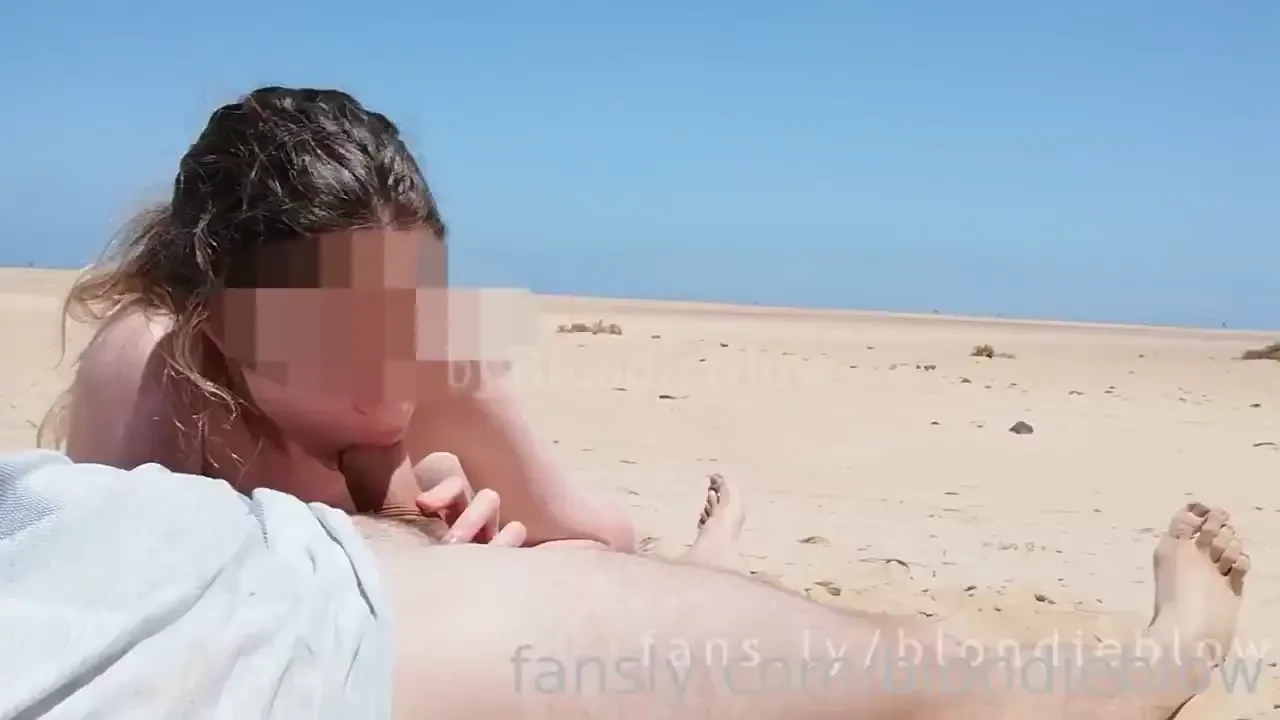 Public blowjob on a beach under the sun 