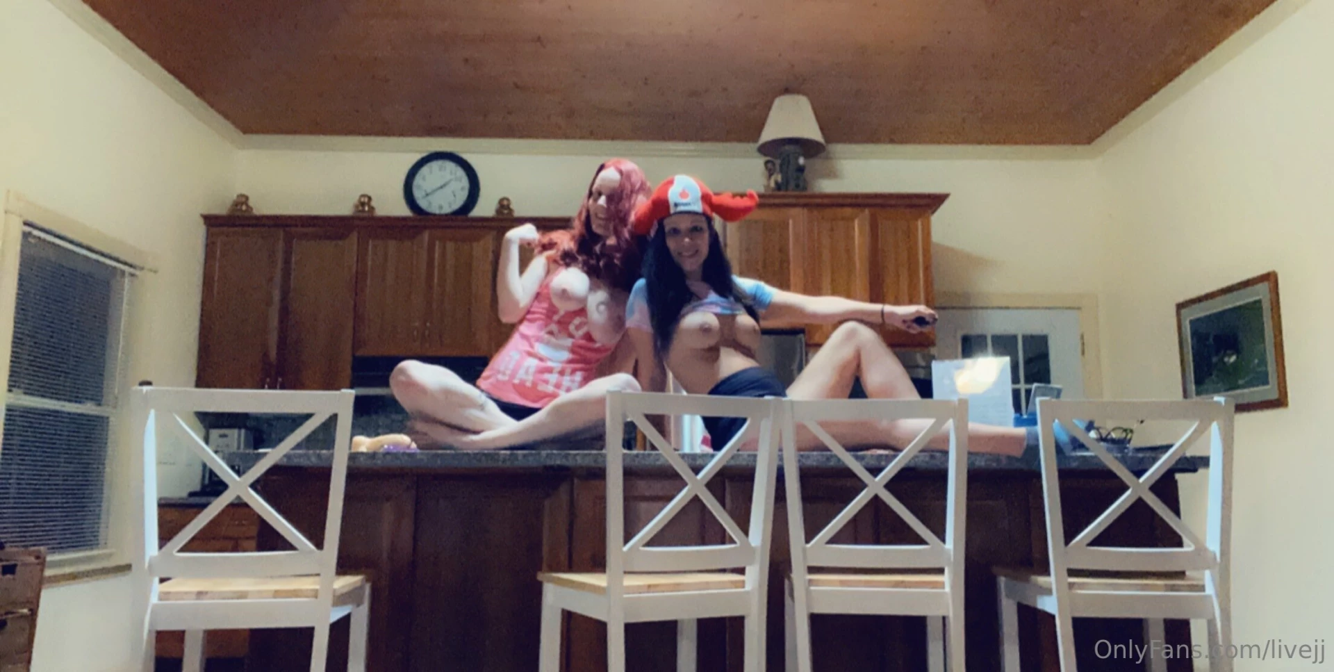 Lesbian fucking on the kitchen counter of an airbnb riding dildos 