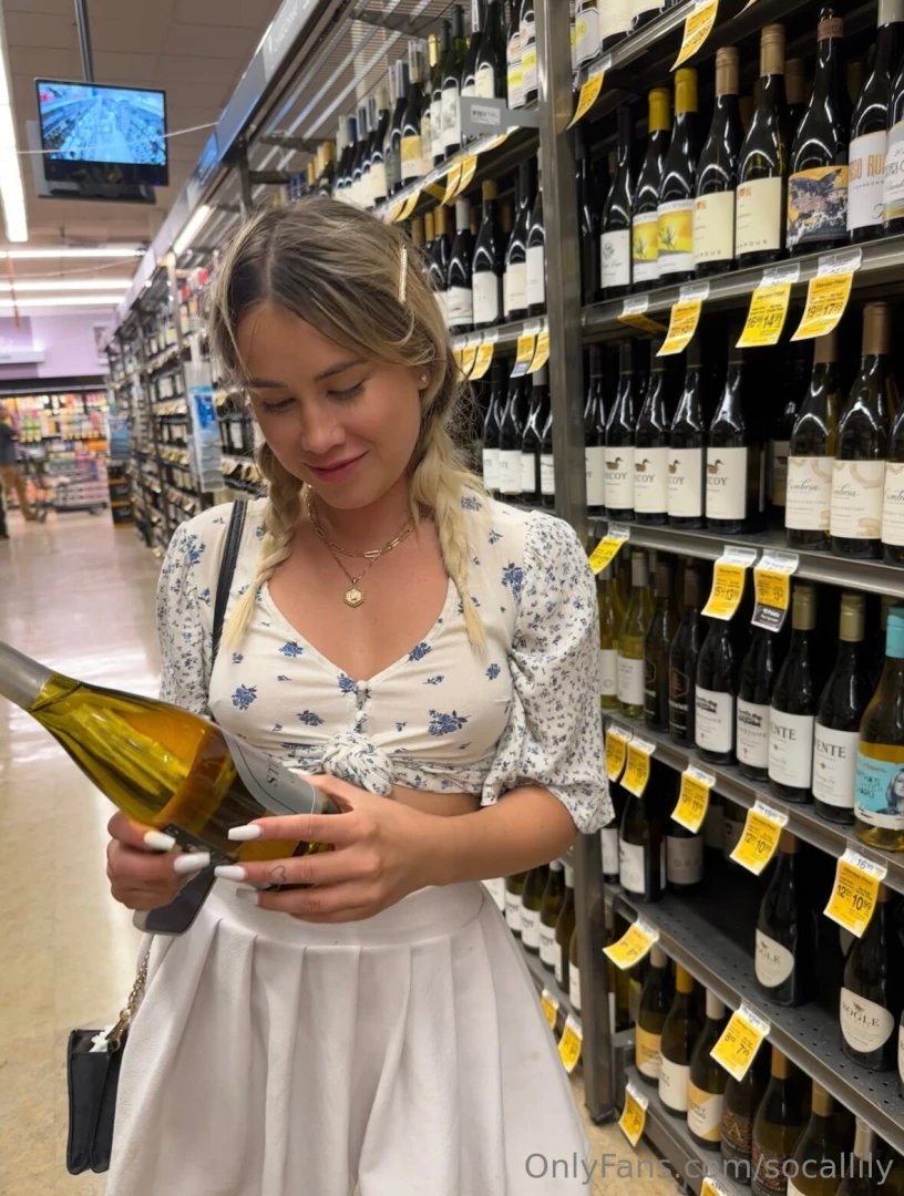 Watch me bend over to grab some wine from the bottom shelf in a small 