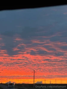 The sun is setting coloring the sky in purple and gold tones an